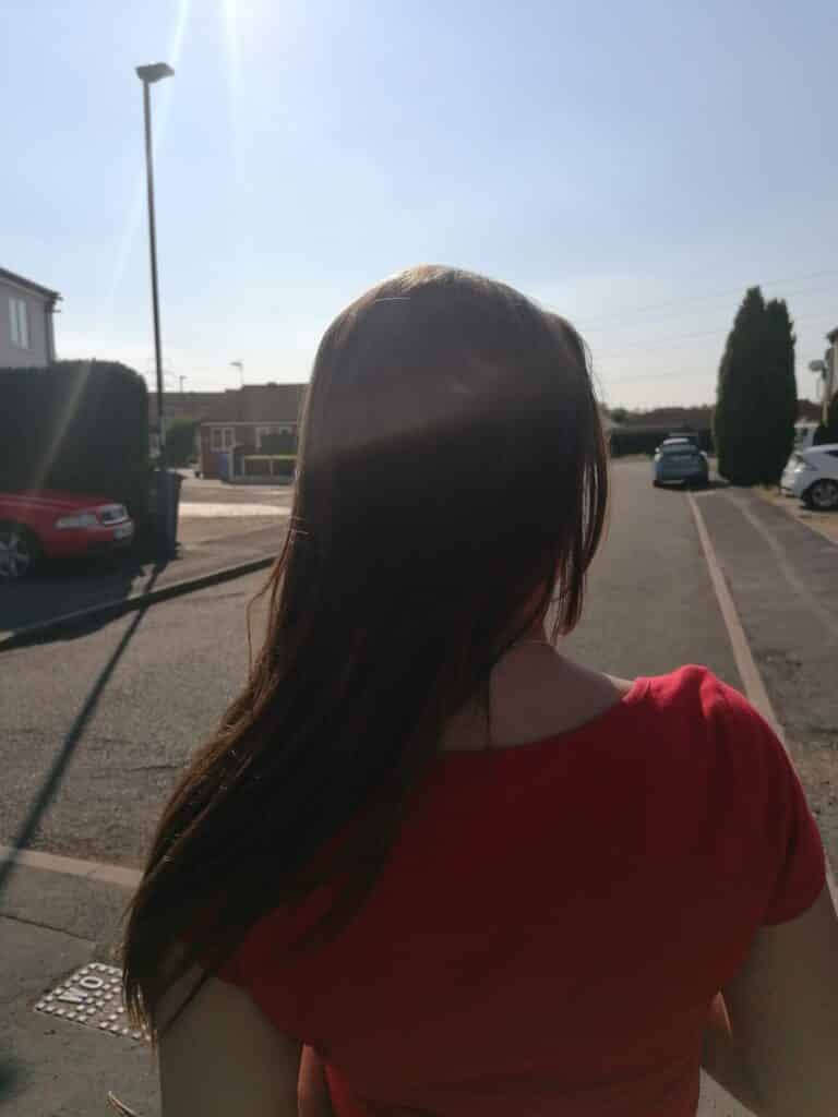 Female with long hair dressed in a red top
