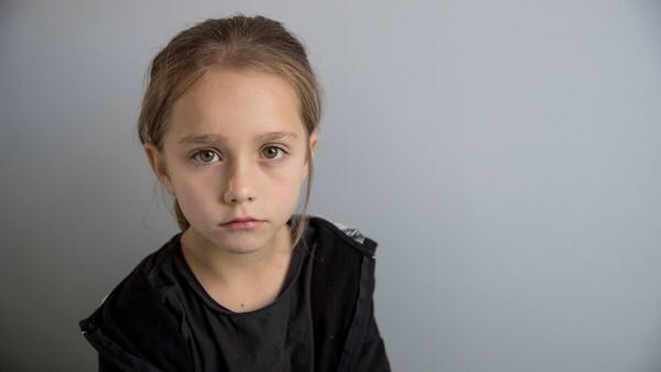 A young girl staring at the camera